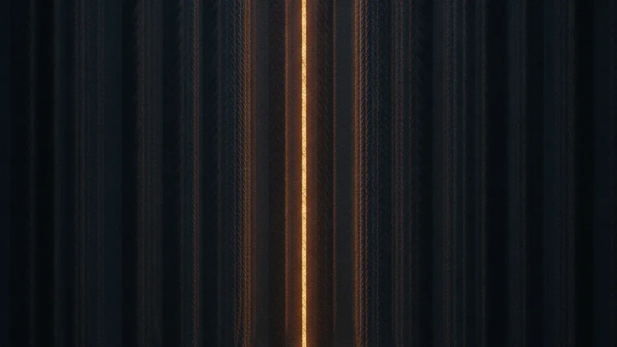 A dense wall of braided cable bundles in a dark room, one single strand glowing warmly from within and traceable through the tangle