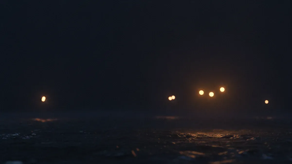 A wide, evenly dark surface across which only a few scattered points of light remain, with no visible connections between them